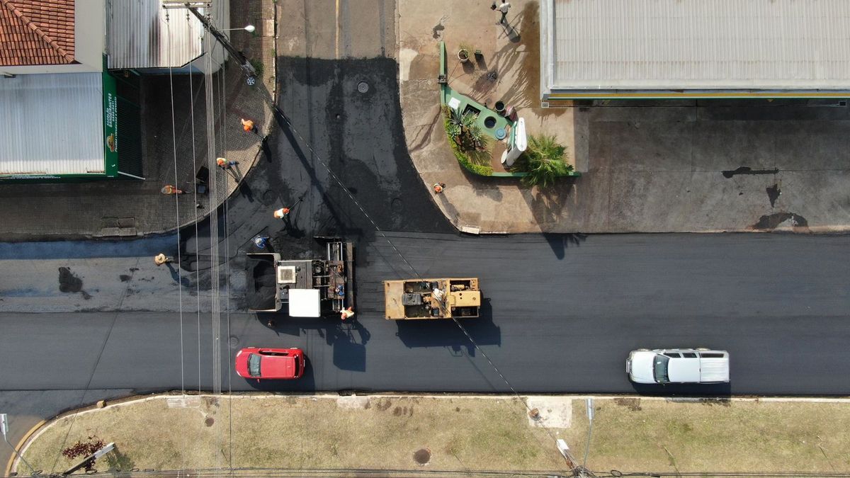 Aerial view of a commercial lot being paved with fresh asphalt